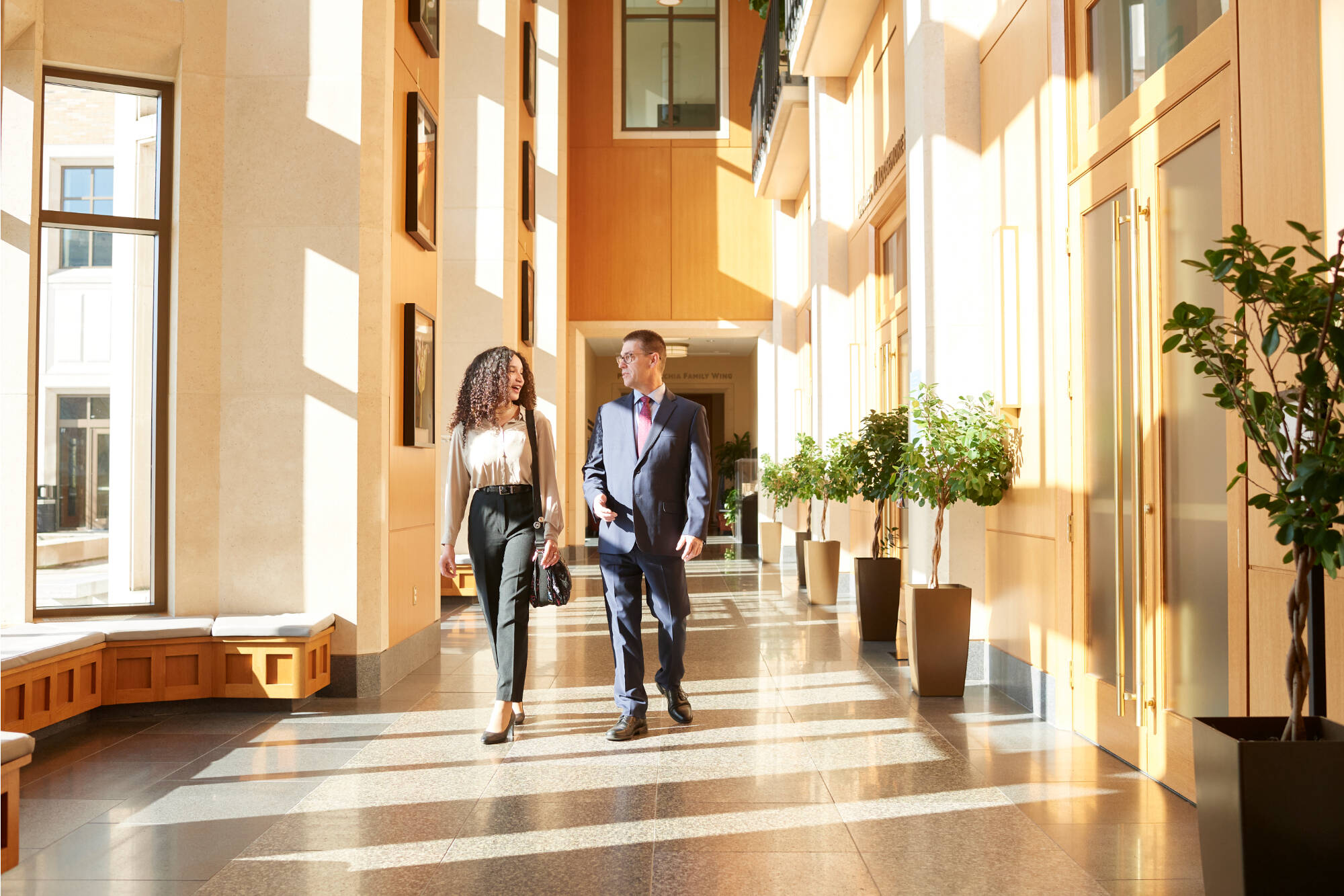 two people walkiong in a hallway